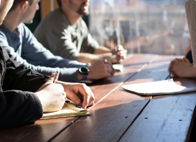 Mensen in gesprek en aan het werk aan tafel